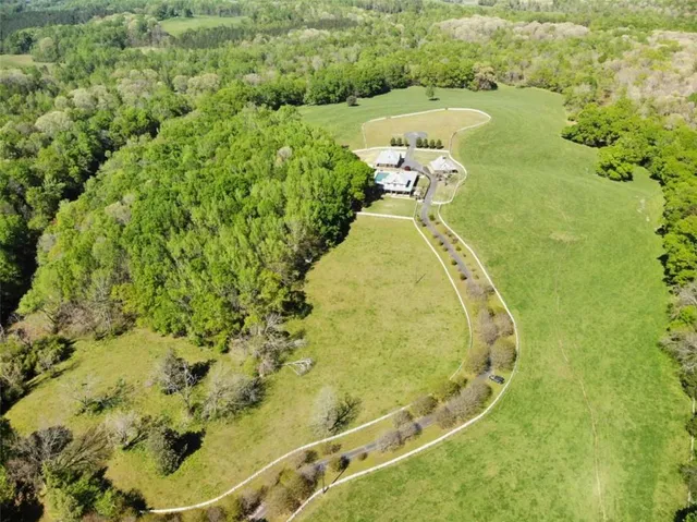 a living room with furniture a large window and wooden floor