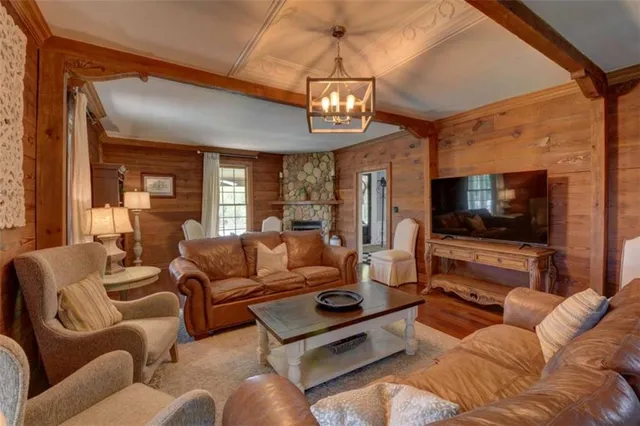 a living room with fireplace furniture and a wooden floor