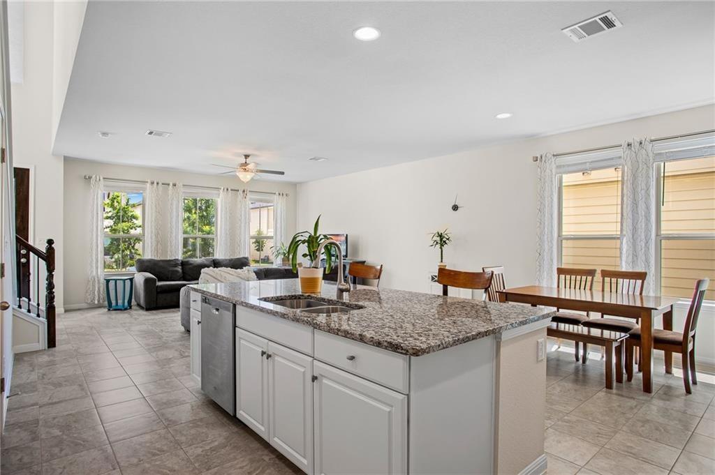 214 Diamond Point Drive Dripping Springs, TX 78620 - Photo 14 of 32 a kitchen with center island table and chairs