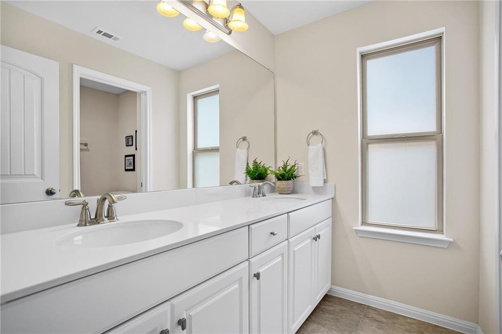 214 Diamond Point Drive Dripping Springs, TX 78620 - Photo 15 of 32 a bathroom with a sink and a mirror