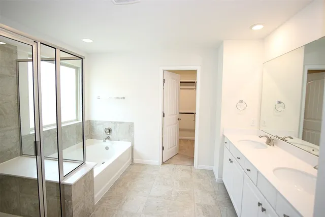a spacious bathroom with a double vanity sink mirror double and bathtub