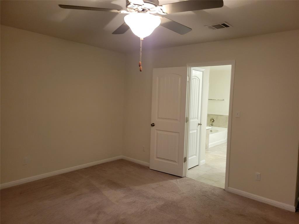 214 Diamond Point Drive Dripping Springs, TX 78620 - Photo 6 of 32 an empty room with a chandelier fan and closet