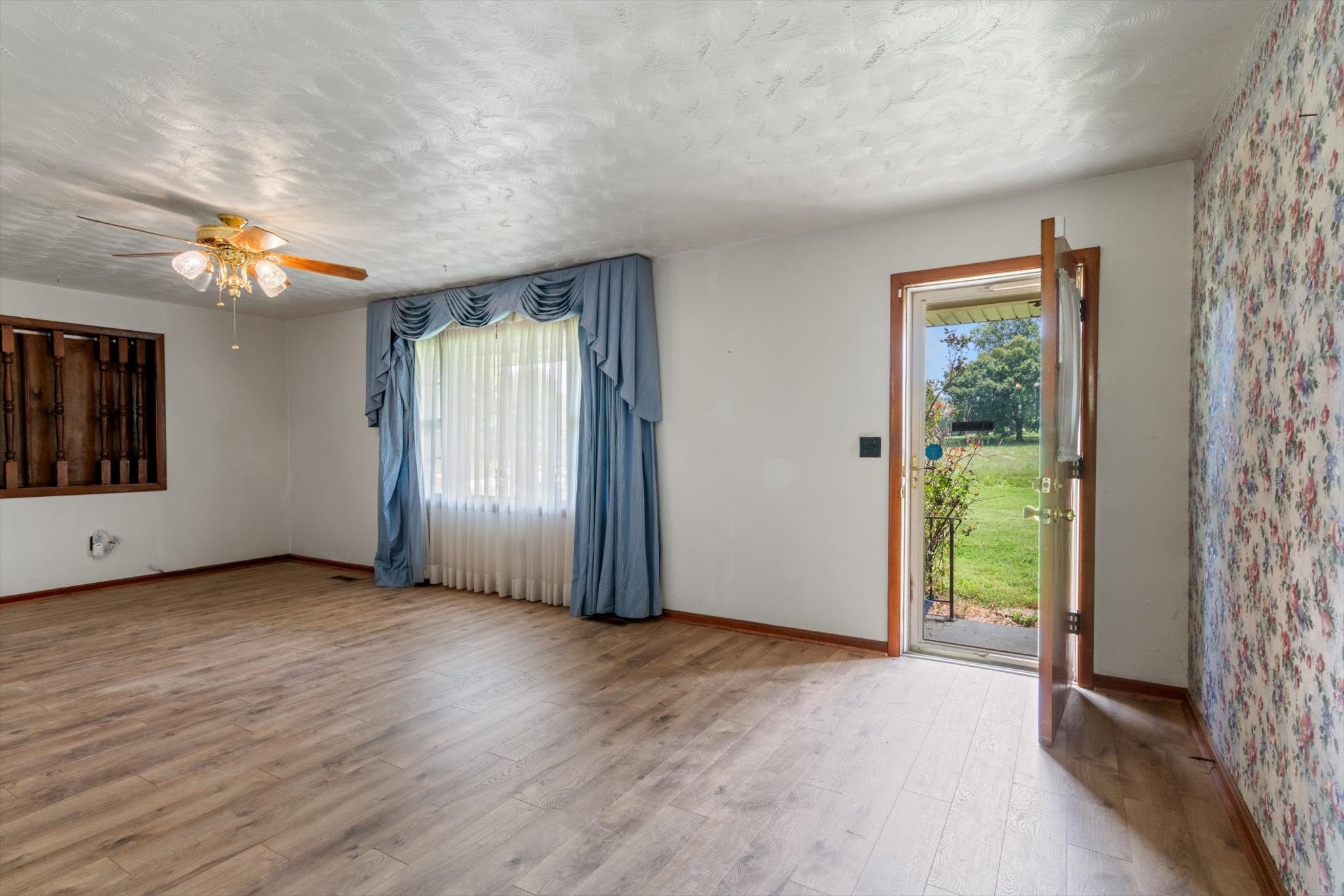5429 Baxter Road Baxter, TN 38544 - Photo 4 of 36 an empty room with windows wooden floor and front door