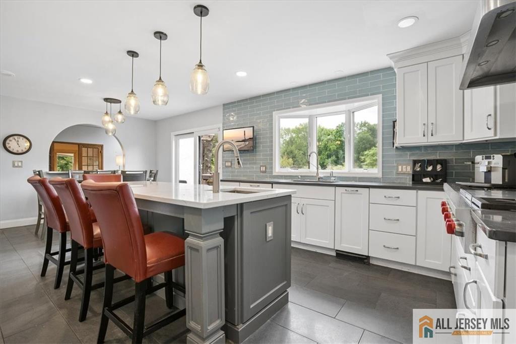167 Federal Road Monroe Township, NJ 08831 - Photo 10 of 46 a kitchen with a stove a sink a dining table and chairs