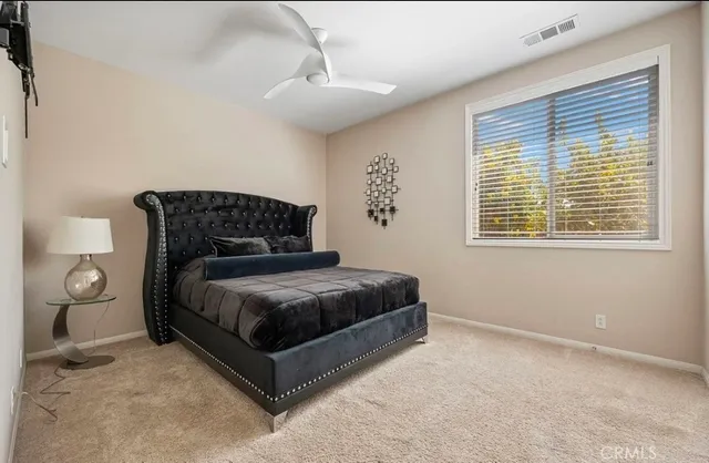 a bedroom with a bed lamp and window