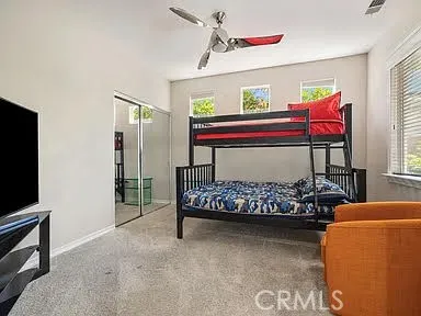 a bedroom with furniture and a flat screen tv