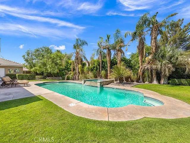 a view of a swimming pool with a yard