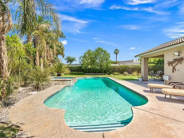 a view of a swimming pool with a patio