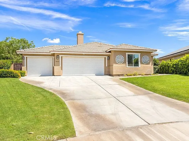 a front view of a house with yard
