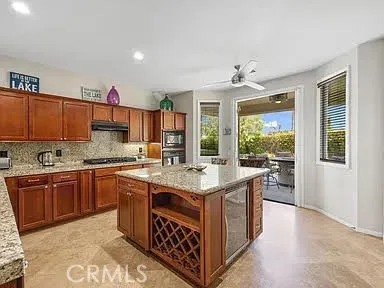 a kitchen with a stove top oven sink and cabinets