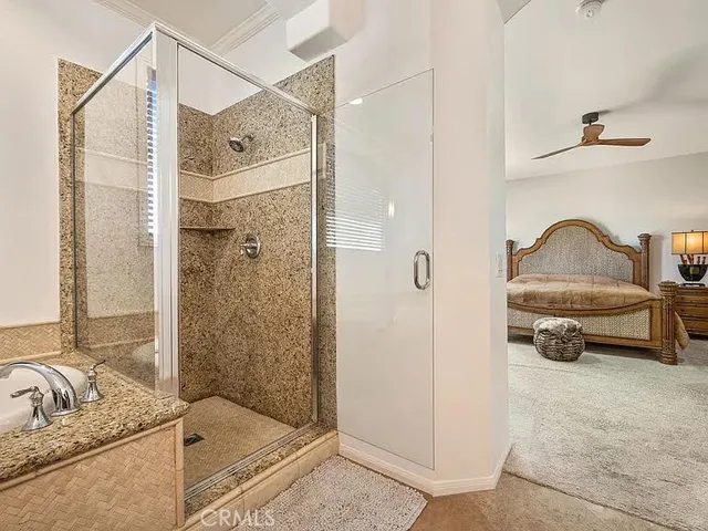 a bathroom with a tub shower and mirror