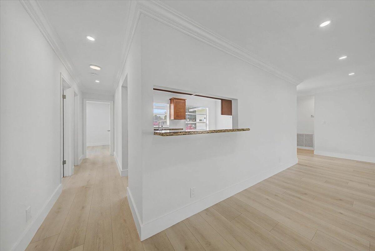 7781 Northwest 46th Street Lauderhill, FL 33351 - Photo 15 of 42 a view of a hallway with wooden floor and a bathroom