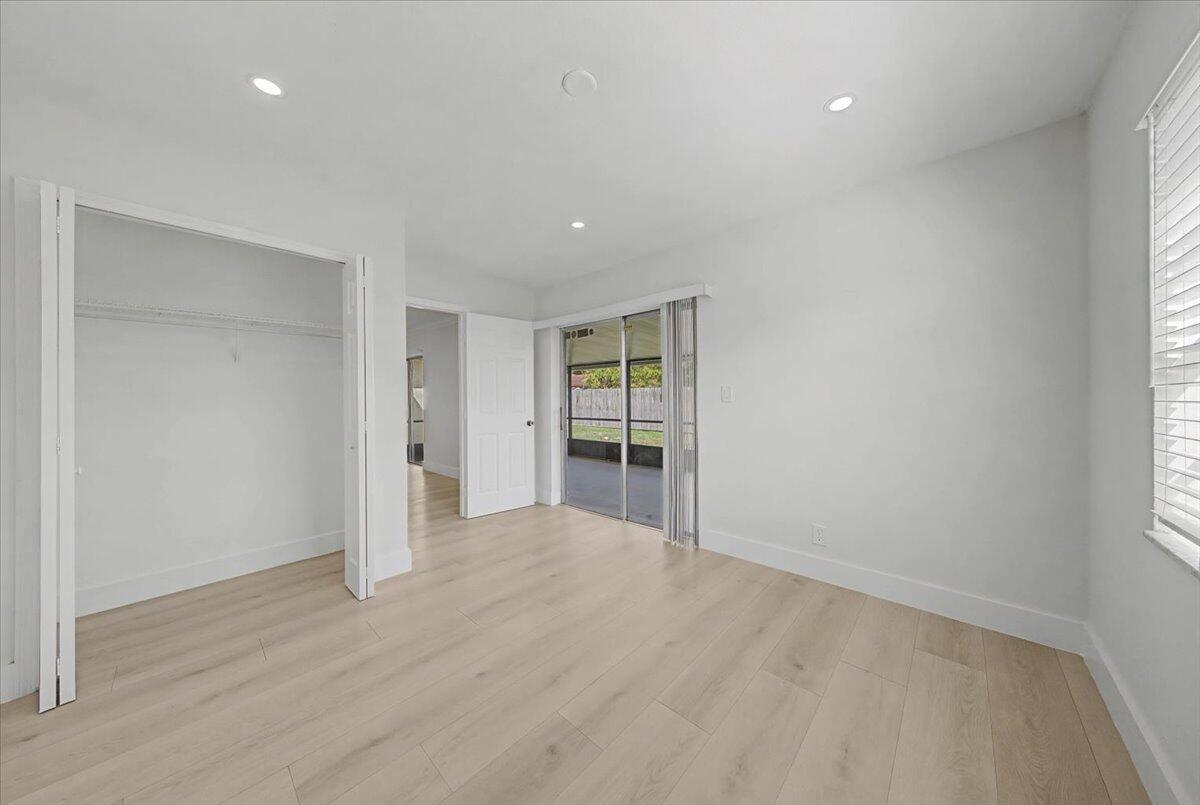 7781 Northwest 46th Street Lauderhill, FL 33351 - Photo 18 of 42 wooden floor in an empty room with a window