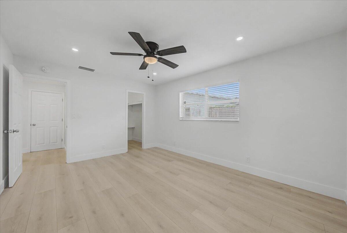 7781 Northwest 46th Street Lauderhill, FL 33351 - Photo 26 of 42 wooden floor in an empty room with a window