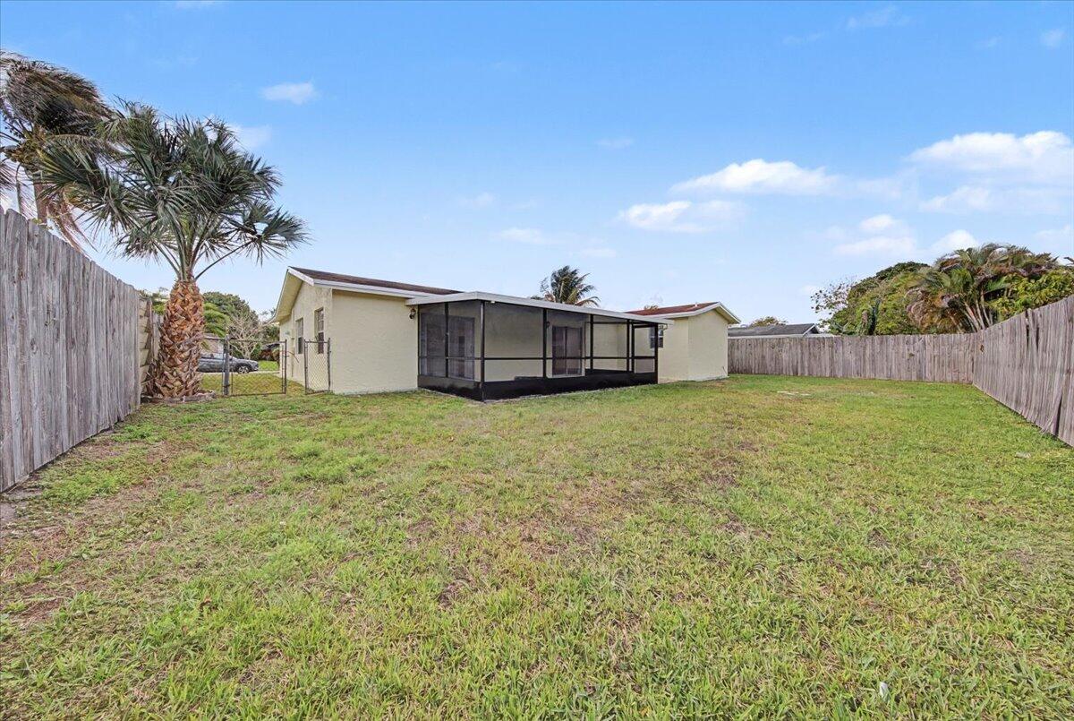 7781 Northwest 46th Street Lauderhill, FL 33351 - Photo 40 of 42 a view of a house with a yard and a garage
