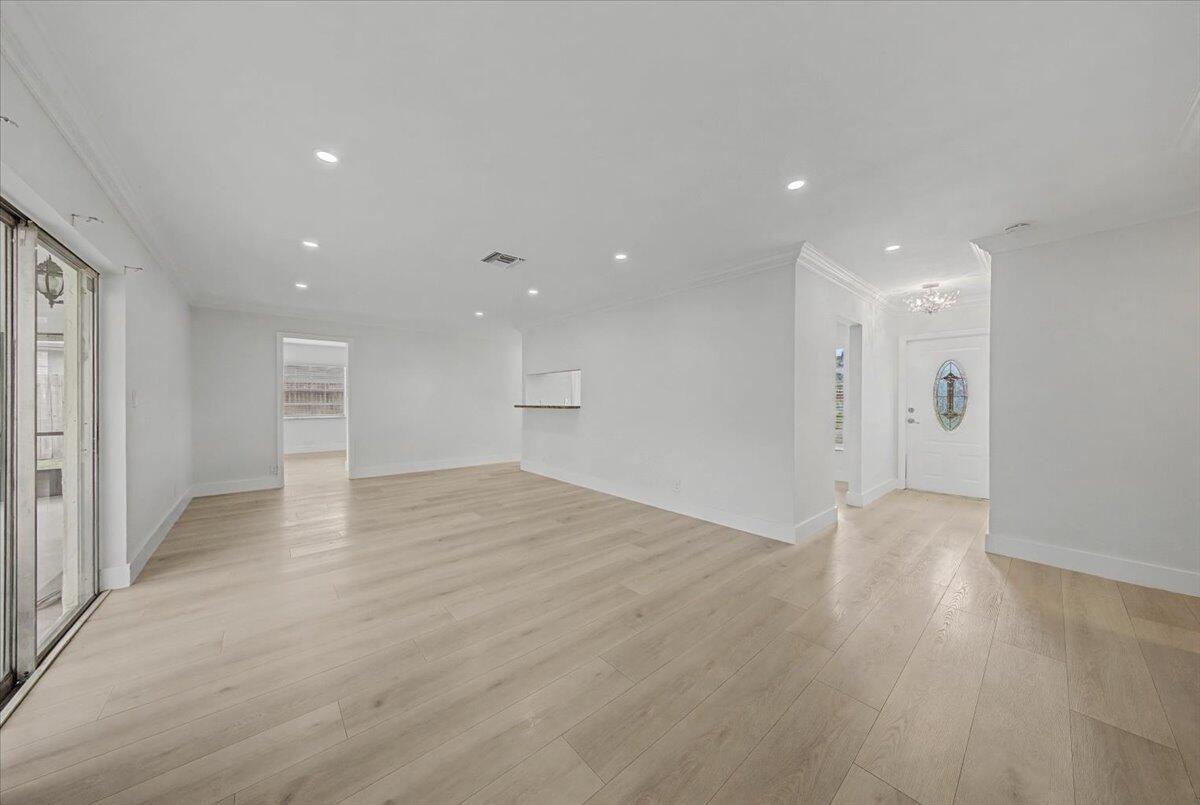 7781 Northwest 46th Street Lauderhill, FL 33351 - Photo 5 of 42 a view of an empty room with wooden floor