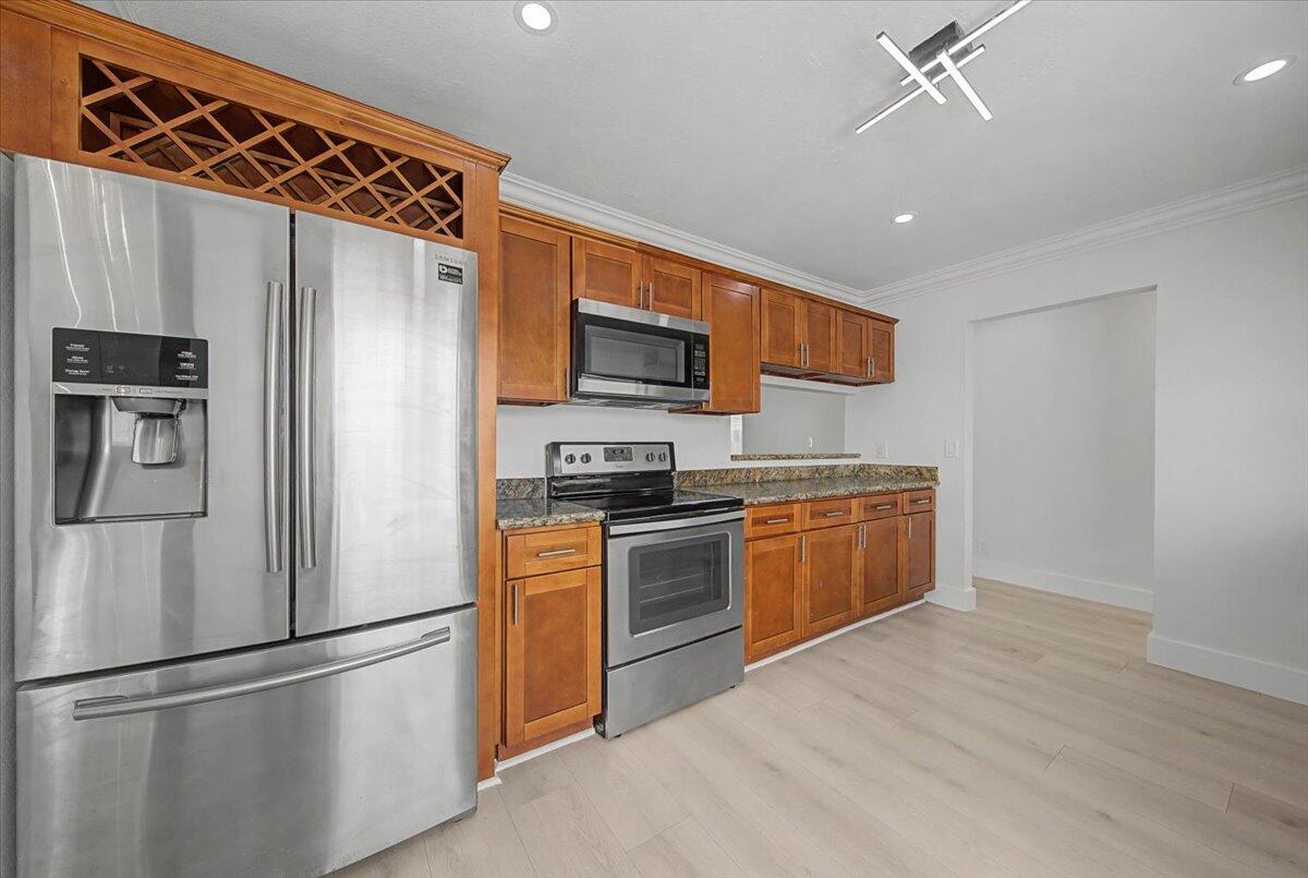 7781 Northwest 46th Street Lauderhill, FL 33351 - Photo 10 of 42 a kitchen with stainless steel appliances granite countertop a refrigerator a stove a sink and a microwave