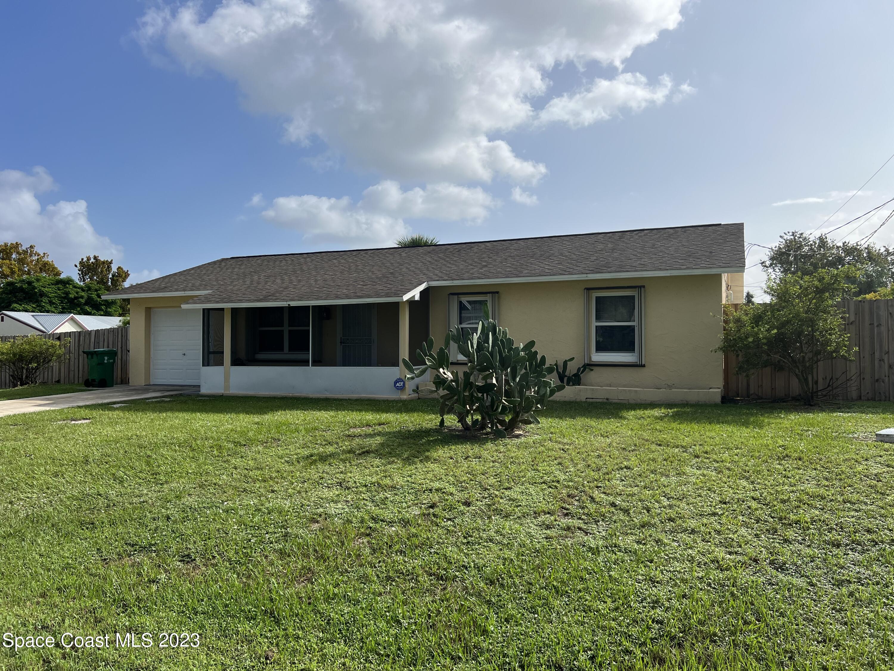 283 Fecco Street Cocoa, FL 32927 - Photo 1 of 25 a front view of house with a garden