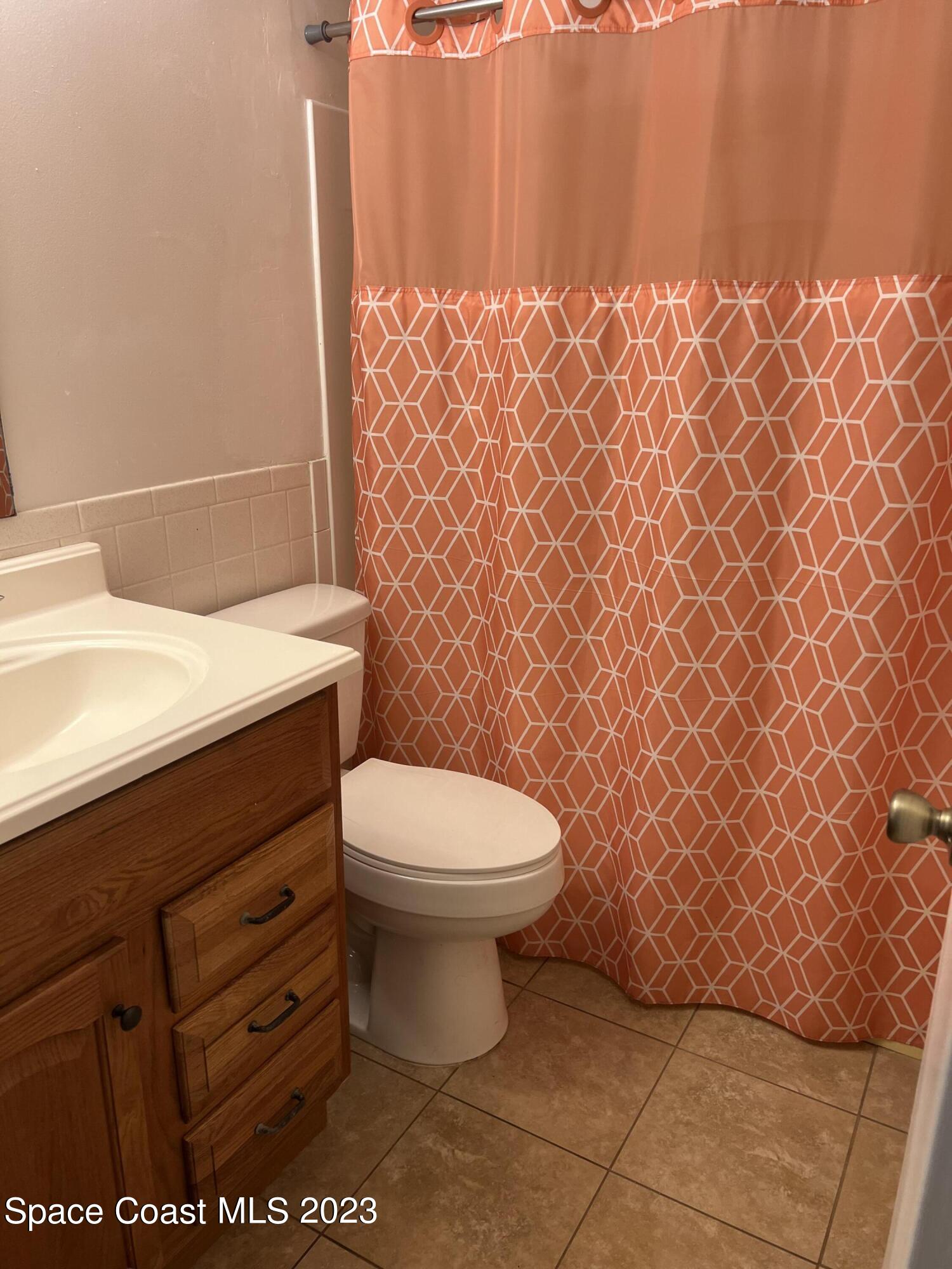 283 Fecco Street Cocoa, FL 32927 - Photo 11 of 25 a bathroom with a toilet and a sink
