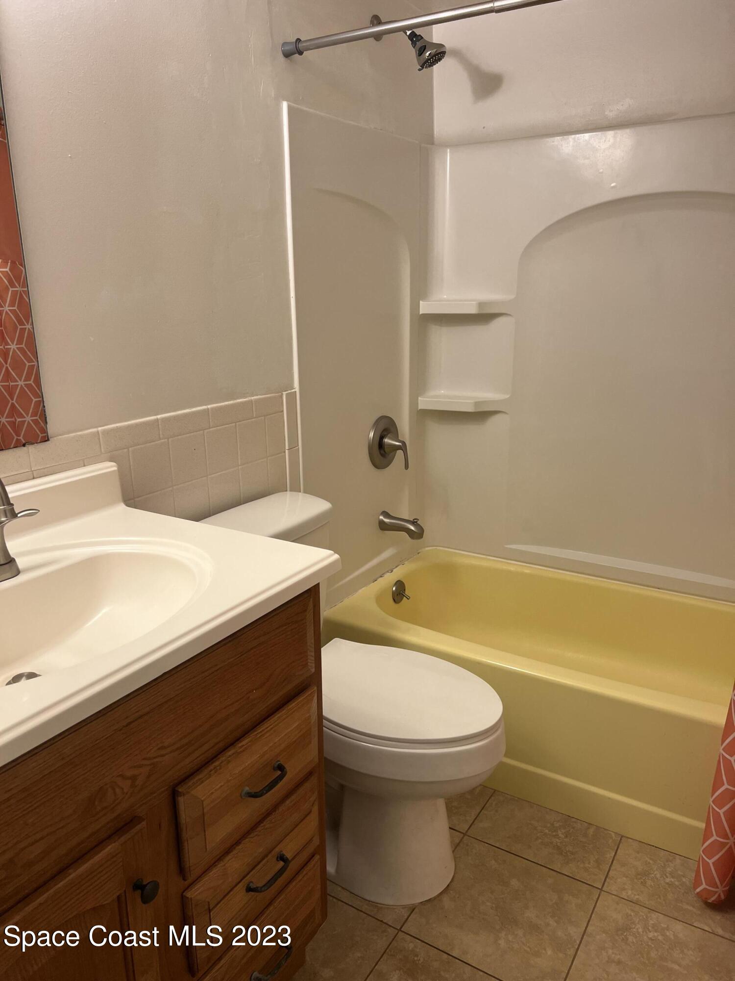 283 Fecco Street Cocoa, FL 32927 - Photo 12 of 25 a bathroom with a sink a toilet and a bathtub