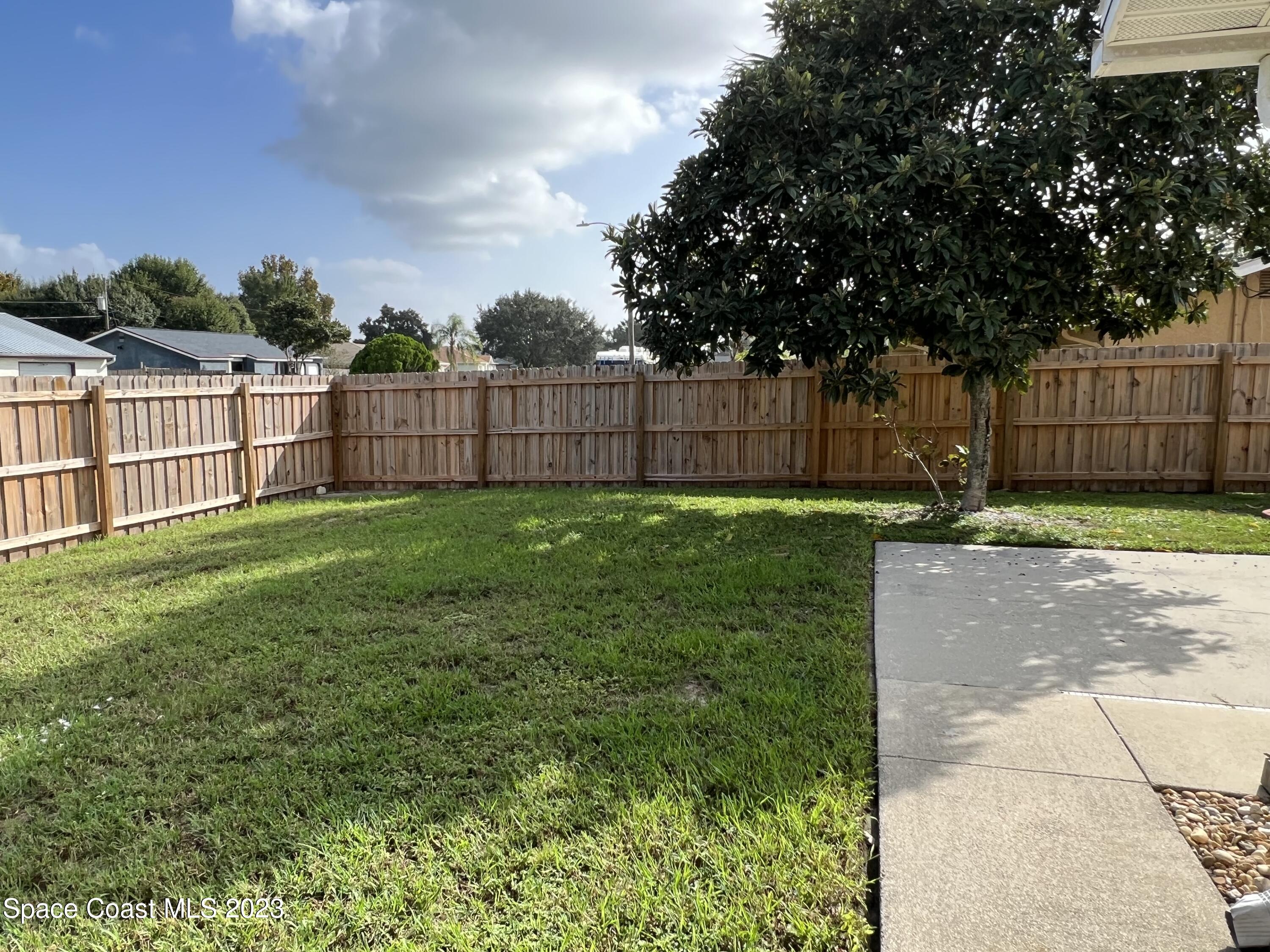 283 Fecco Street Cocoa, FL 32927 - Photo 21 of 25 a view of a backyard with a small cabin