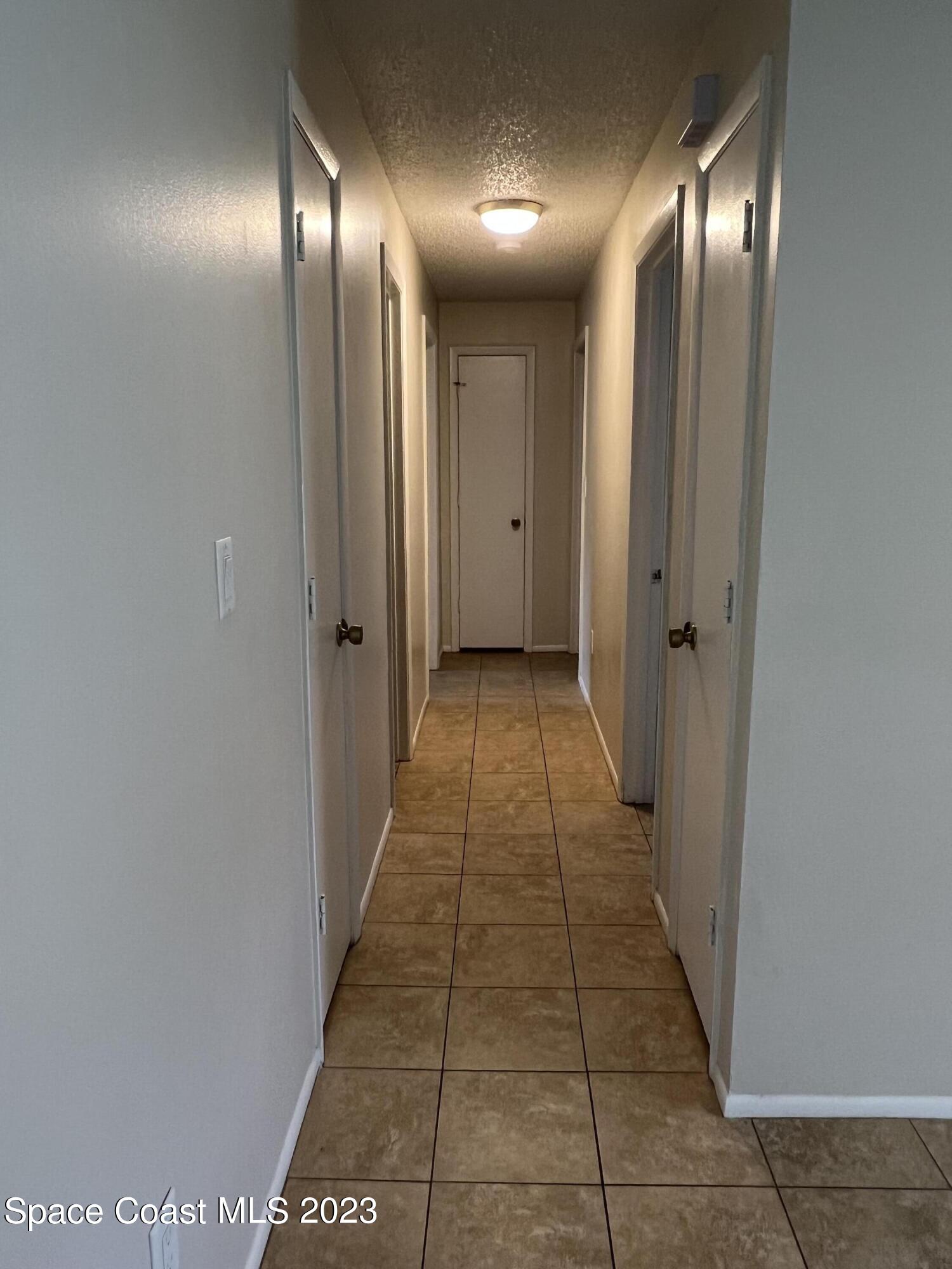 283 Fecco Street Cocoa, FL 32927 - Photo 9 of 25 a view of a hallway with an empty room