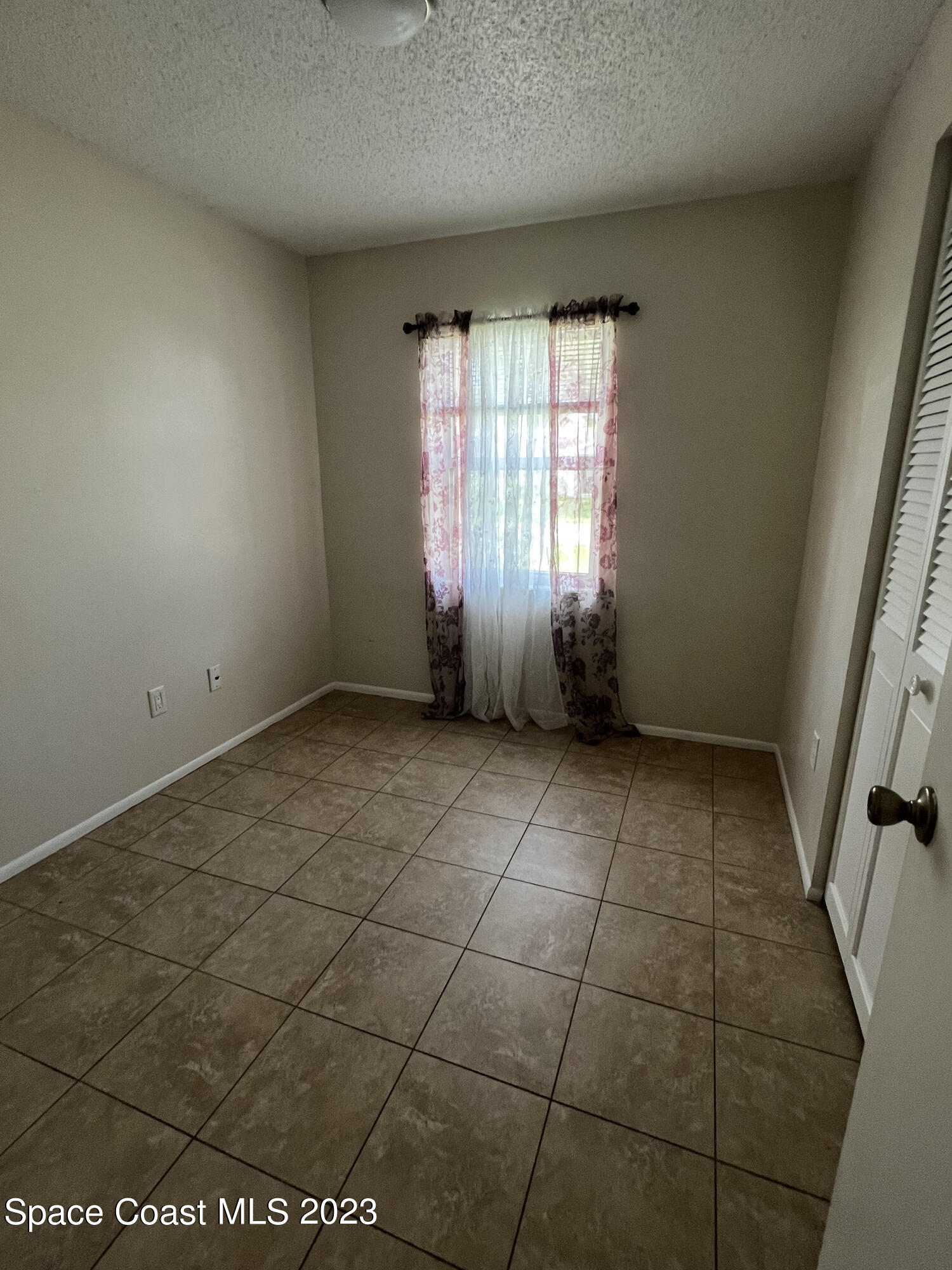 283 Fecco Street Cocoa, FL 32927 - Photo 10 of 25 a view of an empty room and window