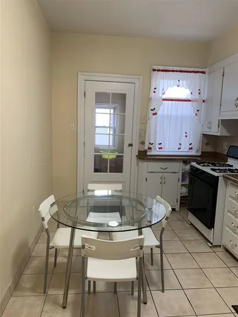 a kitchen with a table and chairs in it