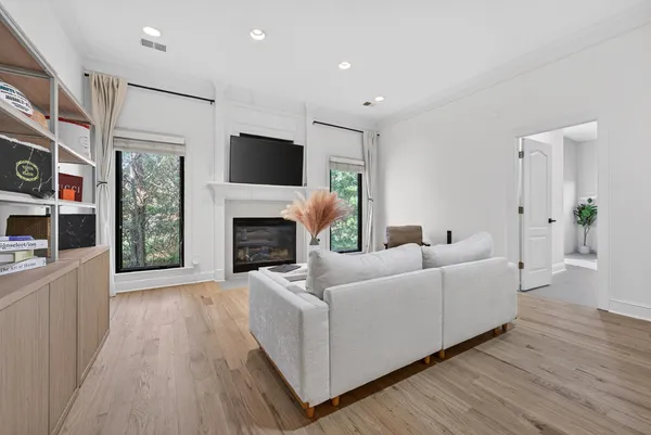 a spacious bedroom with a bed and a chandelier