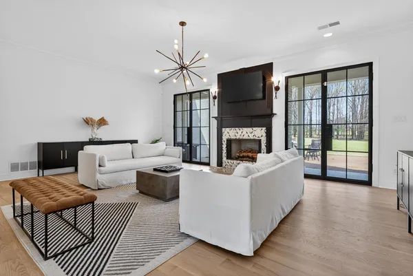 a living room with furniture a flat screen tv and a fireplace