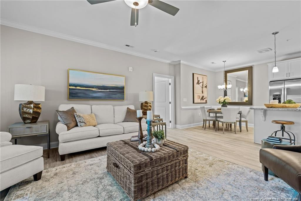 200 Gallery Drive, Unit 201 Spring Lake, NC 28390 - Photo 11 of 17 a living room with furniture potted plant and white walls