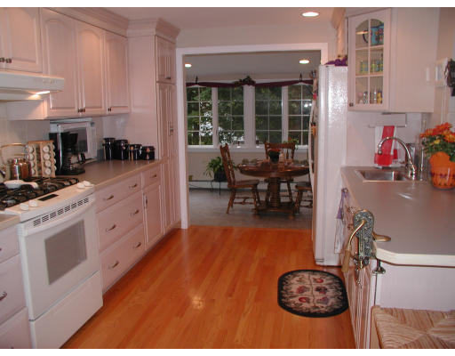 65 Donna Road Needham, MA 02494 - Photo 3 of 8 a kitchen with stainless steel appliances kitchen island granite countertop a stove a sink and a refrigerator