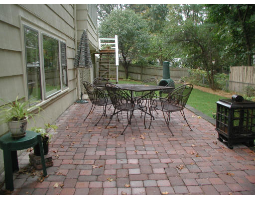 65 Donna Road Needham, MA 02494 - Photo 7 of 8 a view of a tables and chairs in back yard of a house