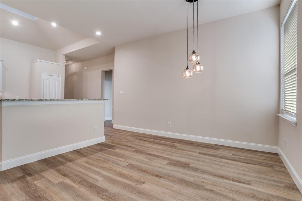 2129 Clubside Drive Corinth, TX 76210 - Photo 15 of 39 an empty room with wooden floor and windows