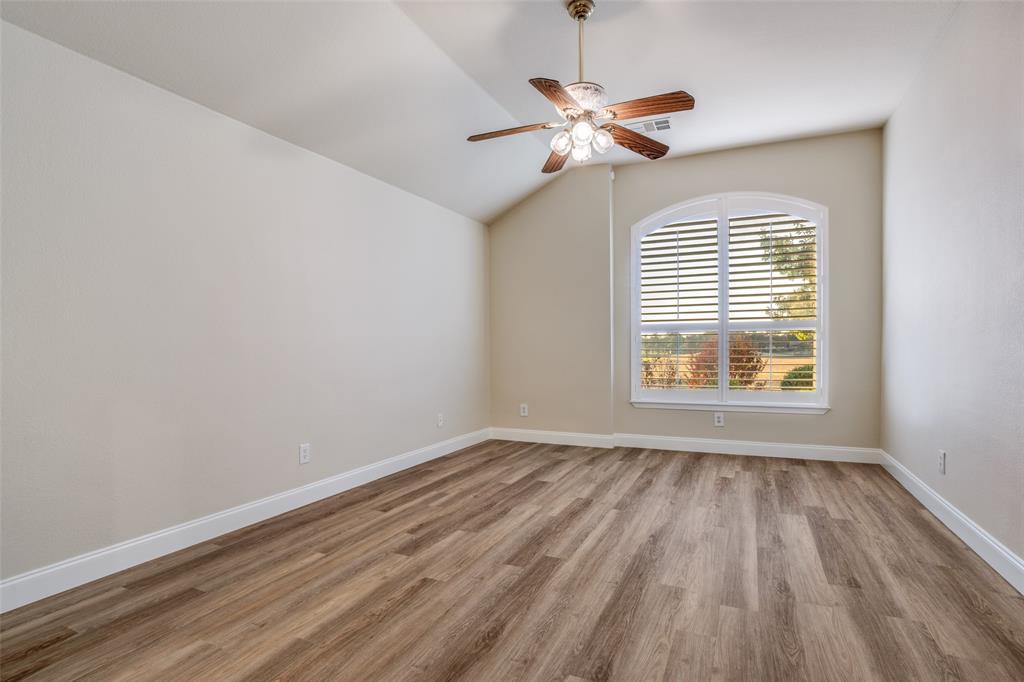 2129 Clubside Drive Corinth, TX 76210 - Photo 17 of 39 a view of an empty room with wooden floor and a window