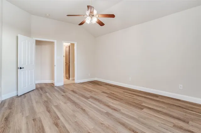 a spacious bathroom with a granite countertop sink and a mirror