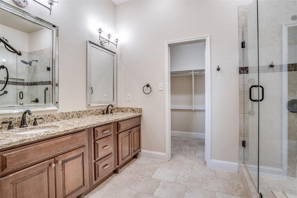 2129 Clubside Drive Corinth, TX 76210 - Photo 19 of 39 a spacious bathroom with a granite countertop sink and a mirror