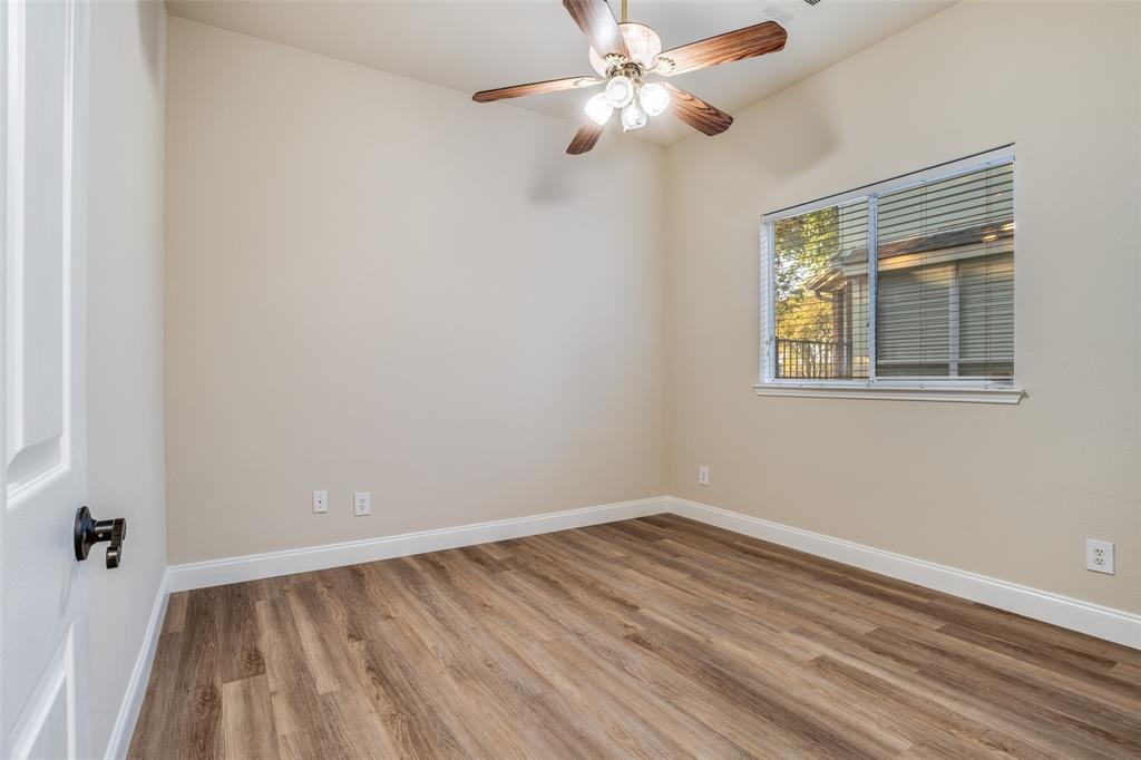 2129 Clubside Drive Corinth, TX 76210 - Photo 38 of 39 a view of an empty room with wooden floor and a window