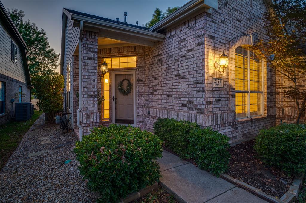 2129 Clubside Drive Corinth, TX 76210 - Photo 2 of 39 a view of a brick house with a large windows