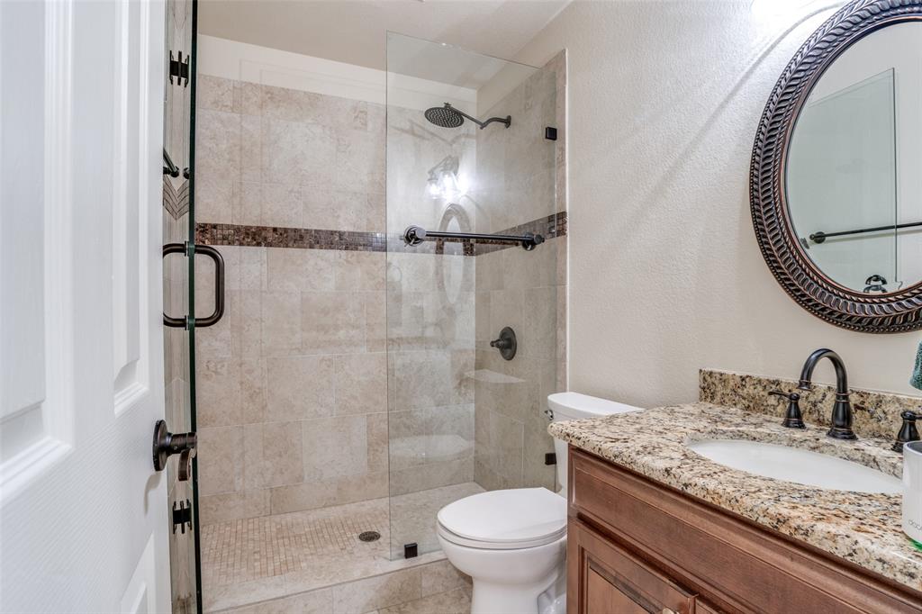 2129 Clubside Drive Corinth, TX 76210 - Photo 20 of 39 a bathroom with a granite countertop sink toilet and shower