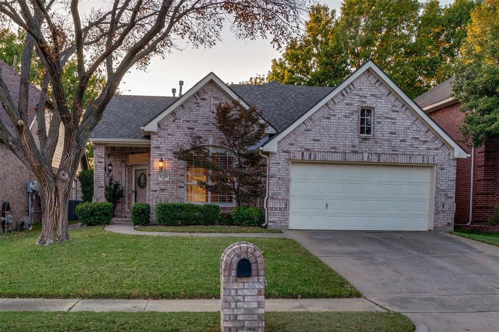 2129 Clubside Drive Corinth, TX 76210 - Photo 3 of 39 a front view of a house with a garden and plants