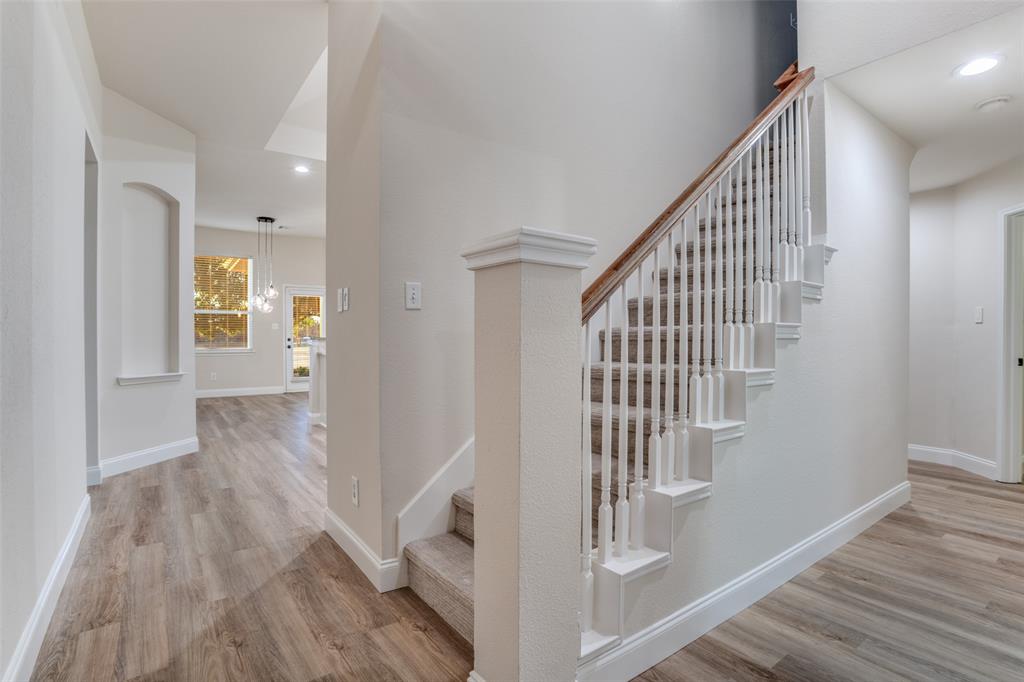 2129 Clubside Drive Corinth, TX 76210 - Photo 6 of 39 a view of hallway with stairs and wooden floor