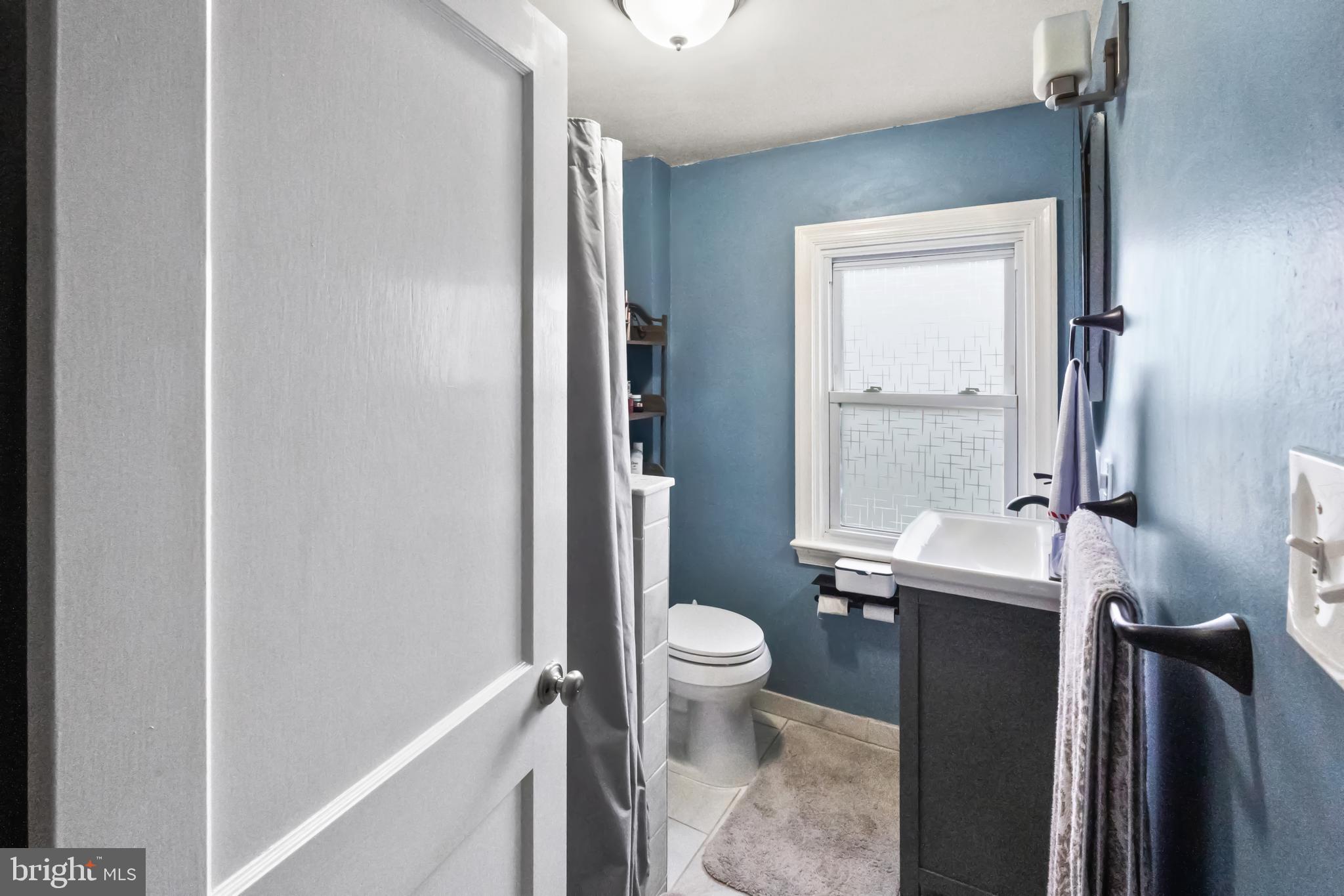 17 Upland Road Brookhaven, PA 19015 - Photo 16 of 25 a bathroom with a sink a toilet and a mirror