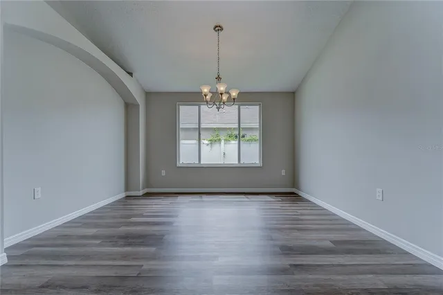 a kitchen with kitchen island white cabinets appliances and a sink