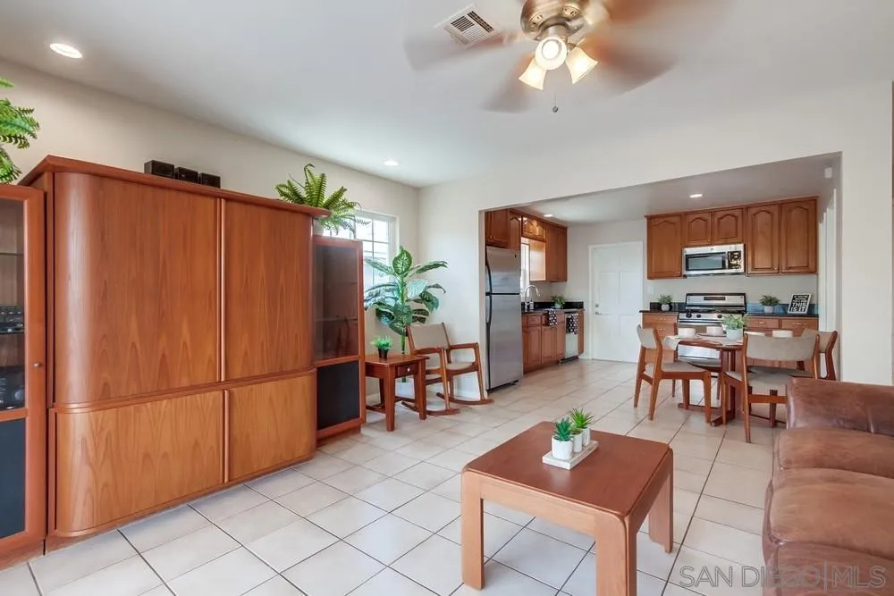 4441 Appleton Street San Diego, CA 92117 - Photo 11 of 29 a living room with furniture a dining table and a refrigerator