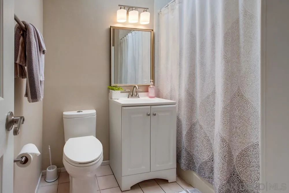 4441 Appleton Street San Diego, CA 92117 - Photo 13 of 29 a bathroom with a sink a toilet and shower