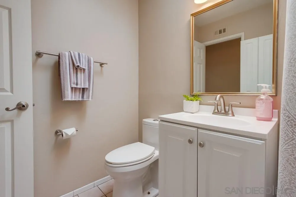 4441 Appleton Street San Diego, CA 92117 - Photo 14 of 29 a bathroom with a sink toilet and mirror