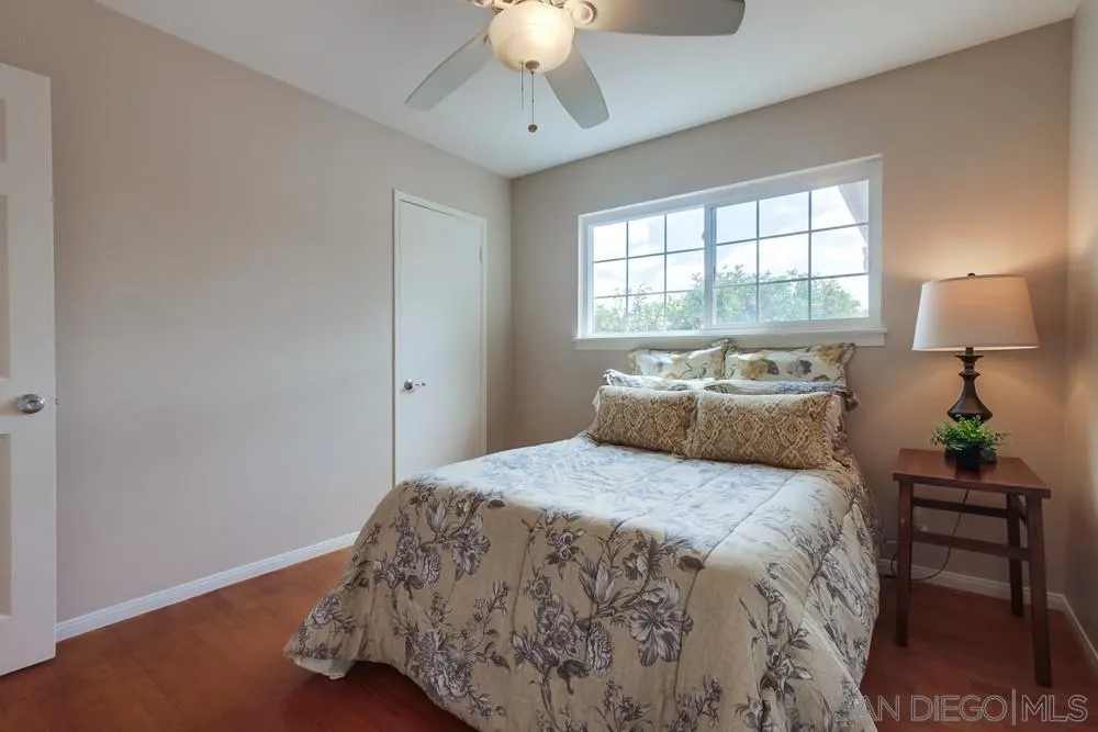 4441 Appleton Street San Diego, CA 92117 - Photo 16 of 29 a bedroom with a bed and a chandelier