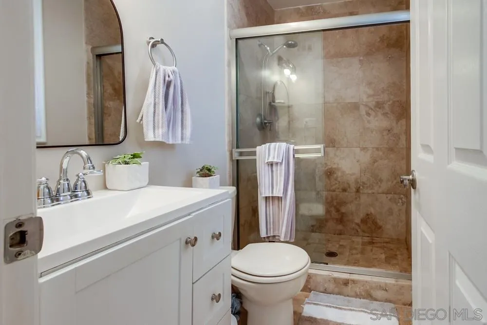 4441 Appleton Street San Diego, CA 92117 - Photo 19 of 29 a bathroom with a sink toilet and shower
