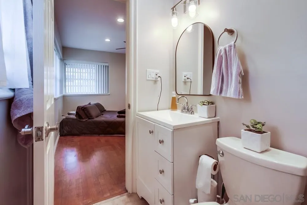 4441 Appleton Street San Diego, CA 92117 - Photo 20 of 29 a en suite bathroom with a toilet sink and mirror